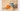 a painting of a kettle with an orange cut in half.